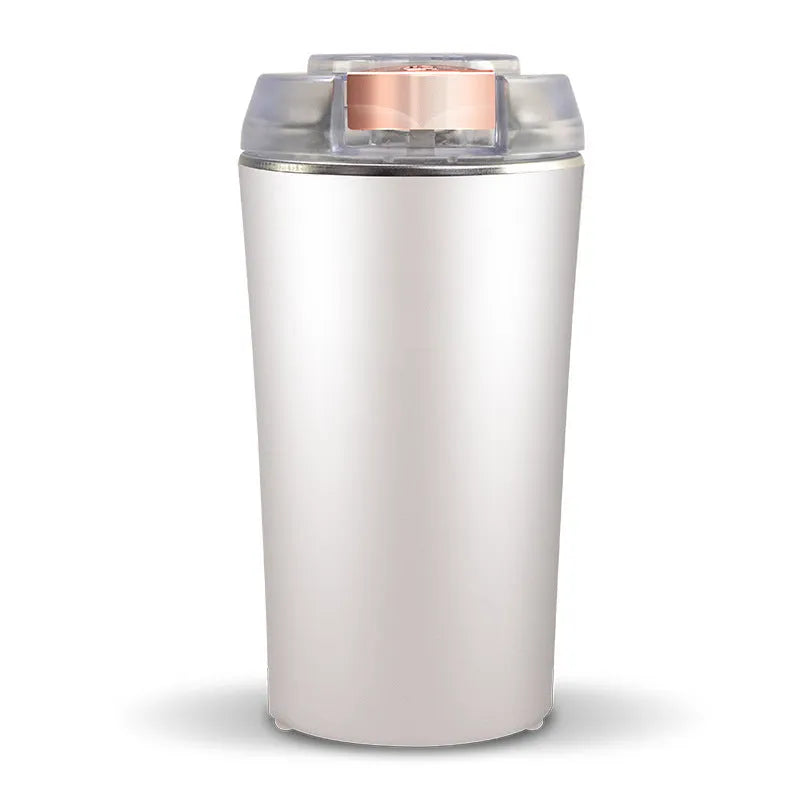 Blue mini flour mill and grain grinder machine with stainless steel construction on a kitchen counter.