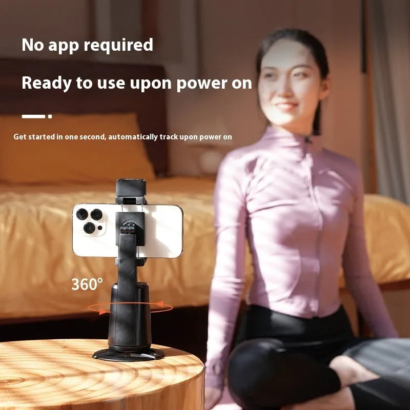 Black desktop mobile phone holder with ribbon lights and remote control for face tracking.