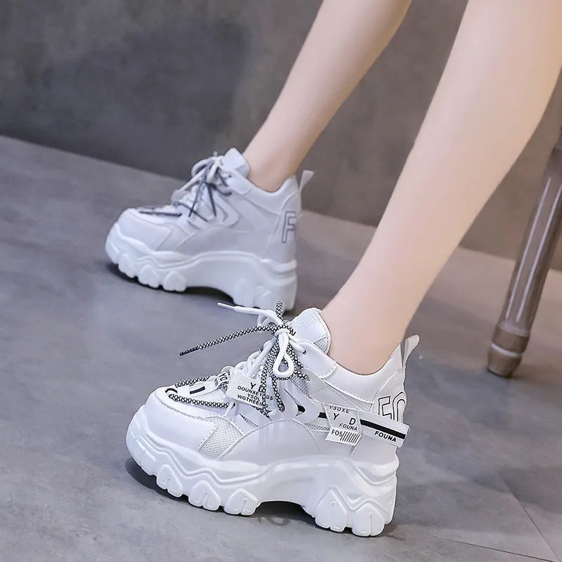 White women's mesh platform sports shoes with cross-strap detail and rubber sole.