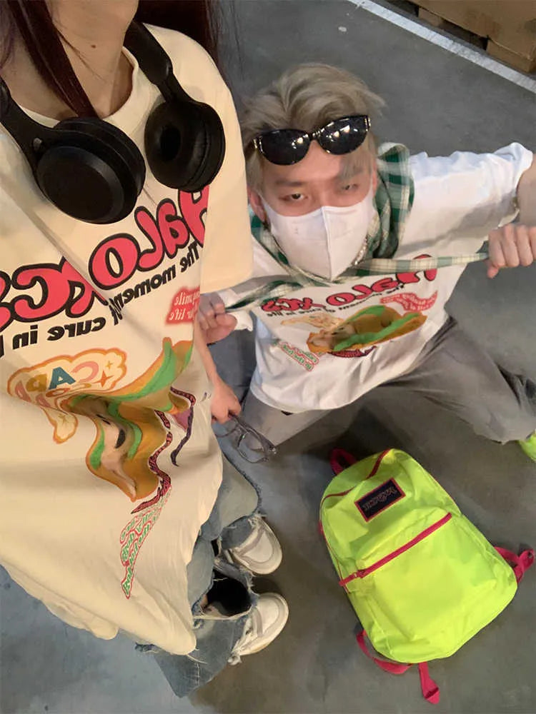 White loose-fit cotton t-shirt featuring a colourful cartoon print of a hamburger and a dog.