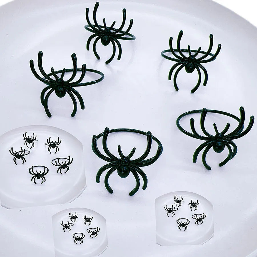 Six black spider-shaped alloy napkin rings for Halloween table decoration