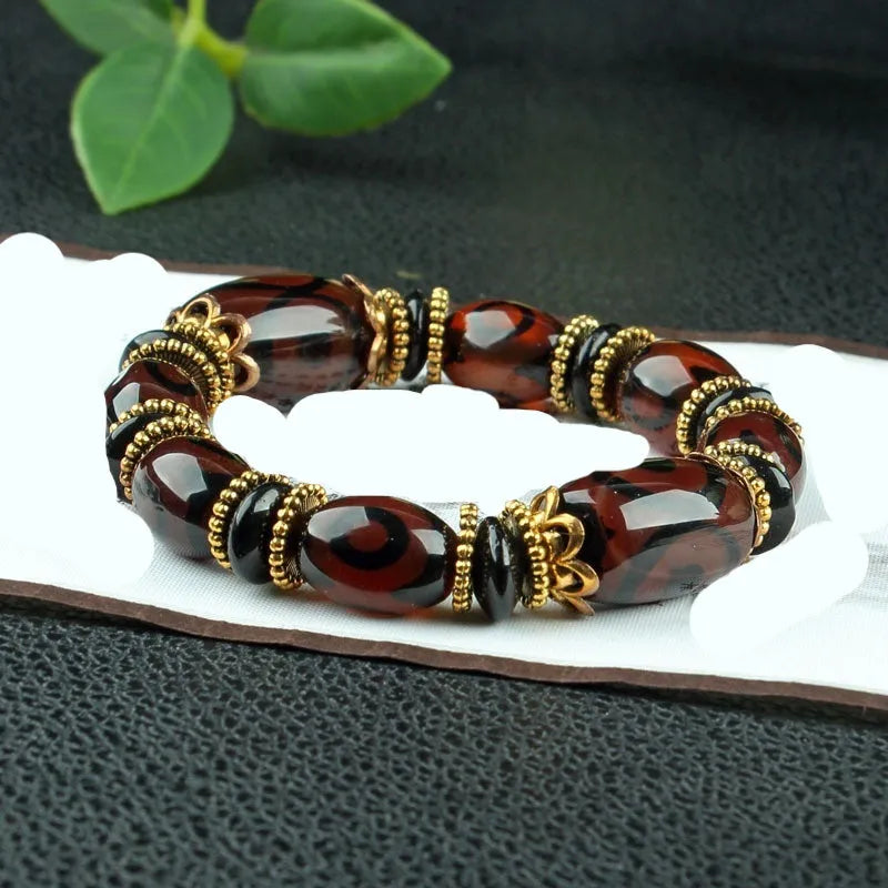 Distressed agate Tibetan beads bracelet featuring Three-eye Dzi and polished agate beads.
