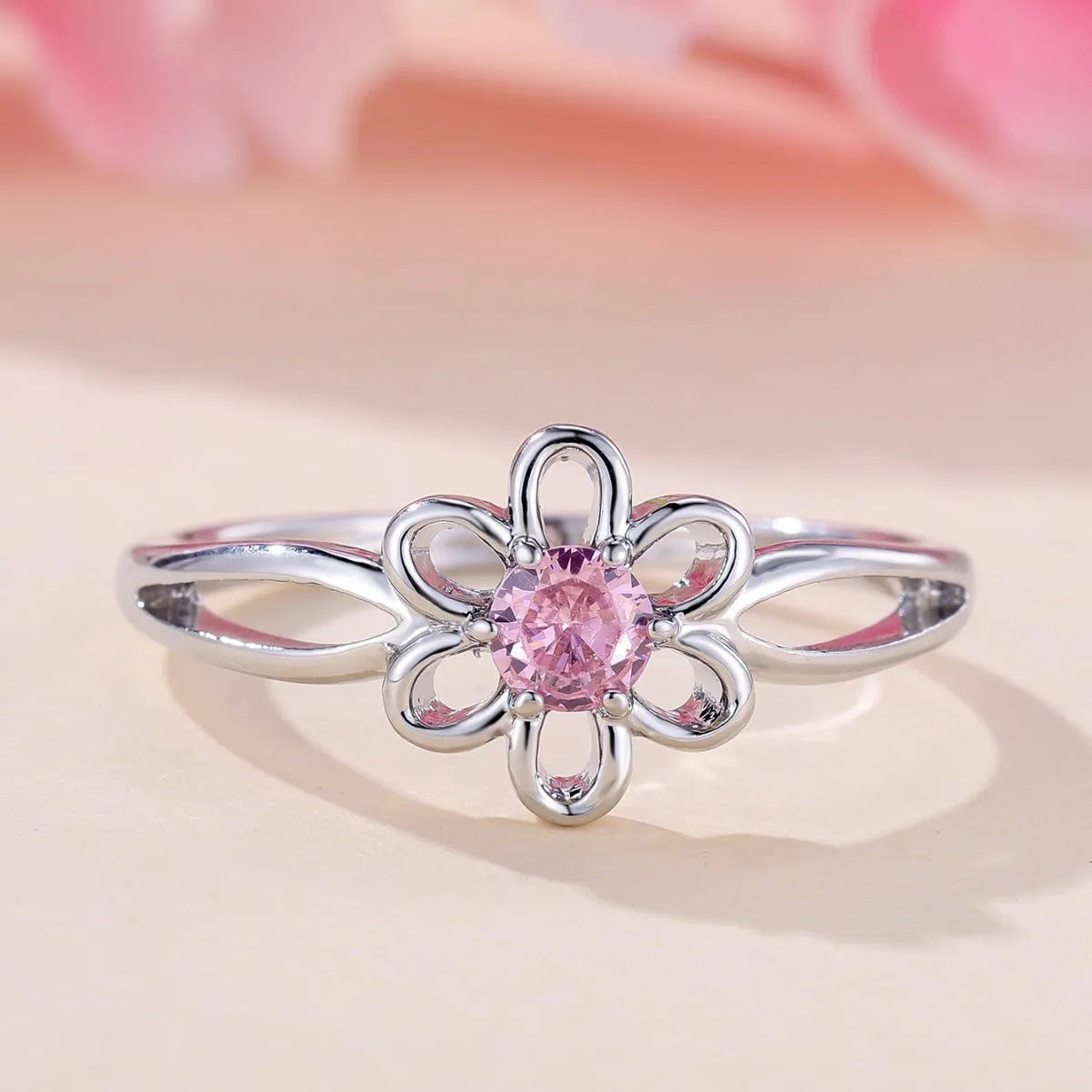Women's fashion ring with hollowed flower pattern in electroplated copper, platinum pink diamond colour