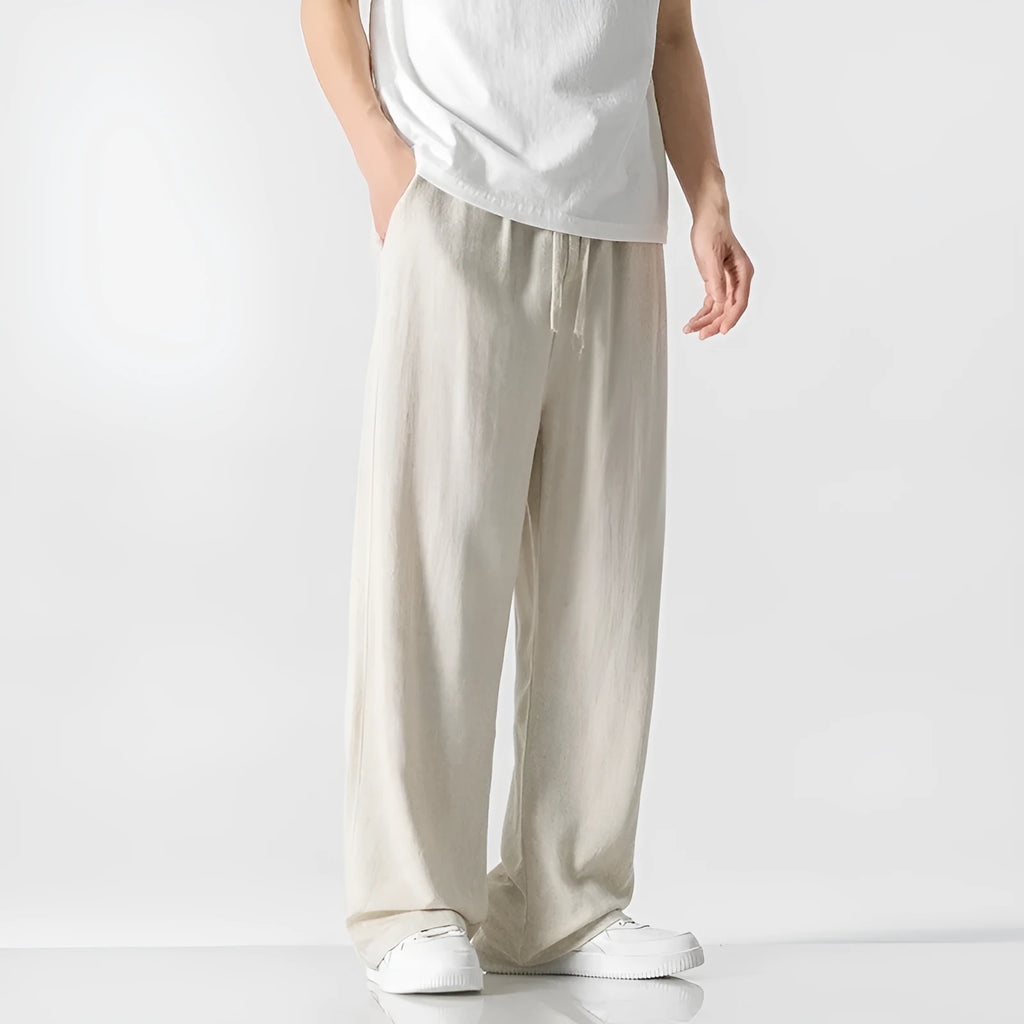 Men's beige bamboo fibre loose straight-leg casual trousers with a drawstring waist, shown on a hanger.