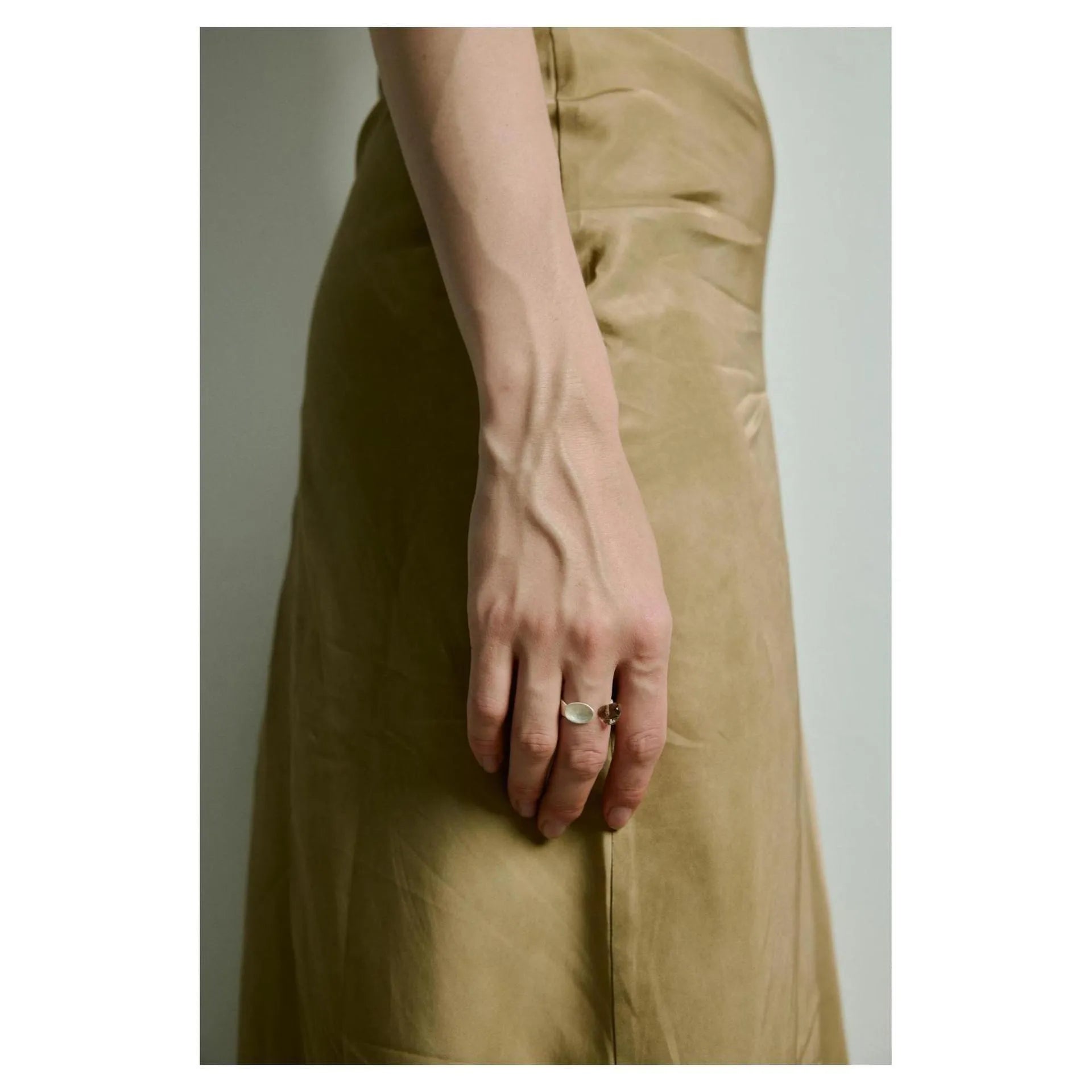 Silver tone alloy ring and bracelet set with a small stewed pork motif on diamond-shaped charms.