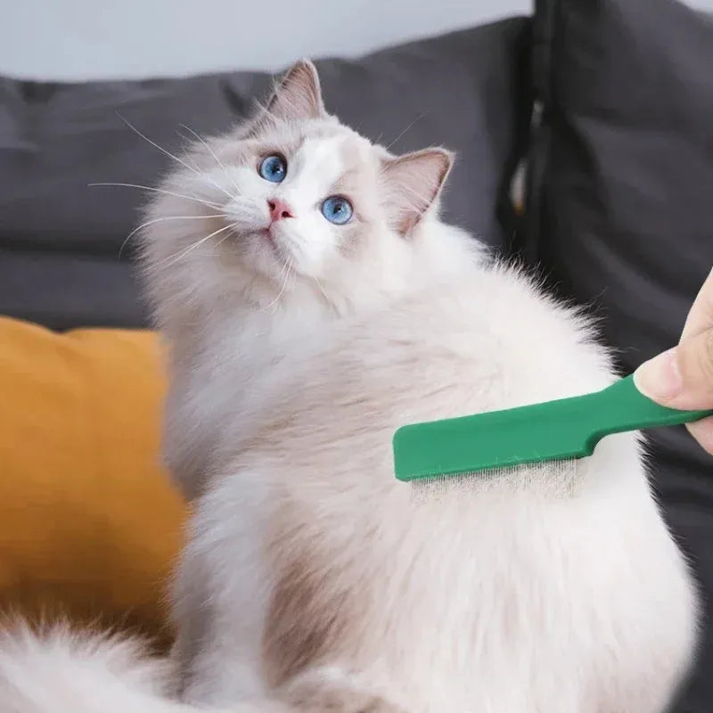 Green plastic-handled flea comb with stainless steel pins for dog and cat grooming.
