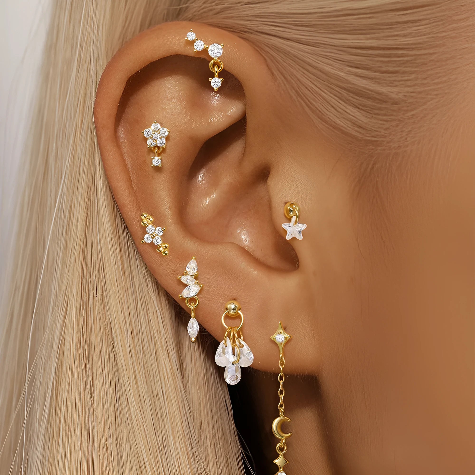 S925 sterling silver geometric moon and star earrings with diamond detail in a gold colour.