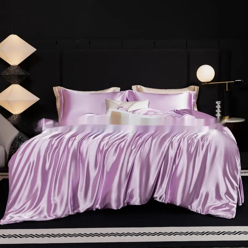 Silk bed sheet four-piece set in a solid colour, shown draped over a bed in one of seven available colours.