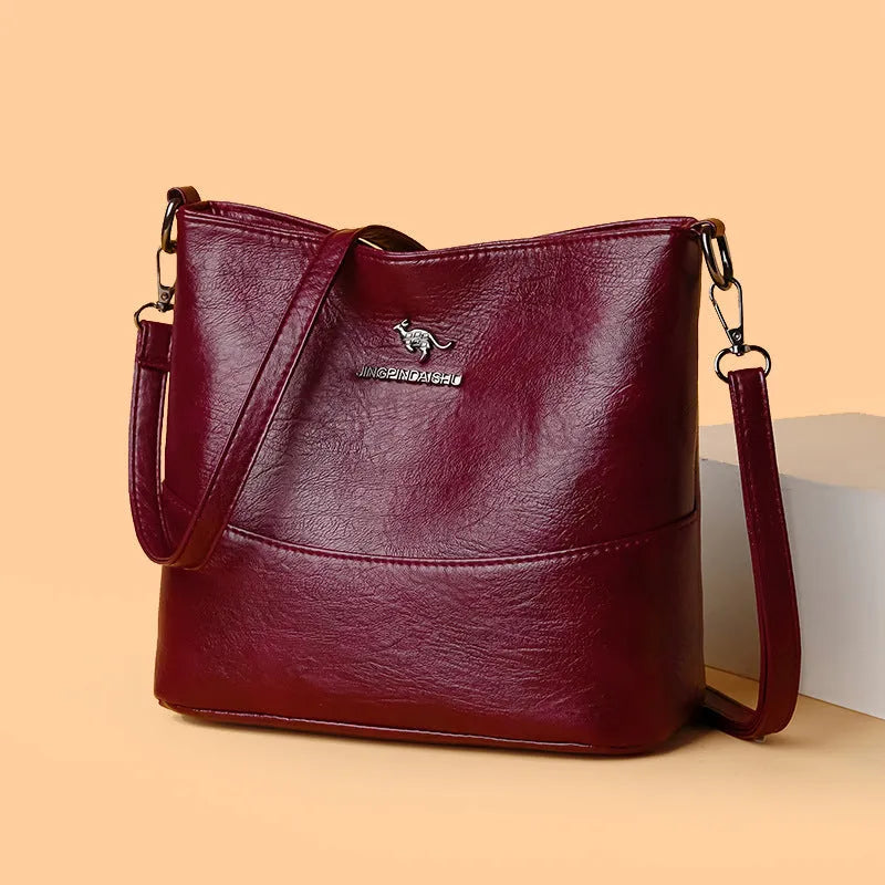 Women's soft leather large capacity bucket shoulder bag in minimalist luxury style with sewing line details.