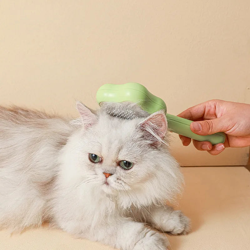 Green or yellow self-cleaning cat comb with stainless steel teeth, showing 20cm length.