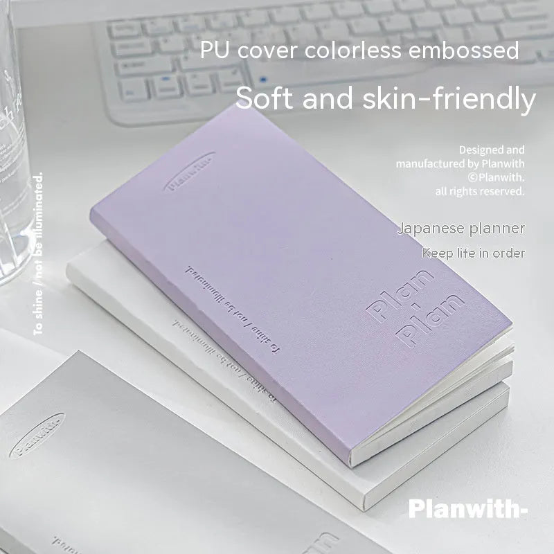 Embossed A5 daily meter book notebook showing blue, grey, purple, and white cover colour options.