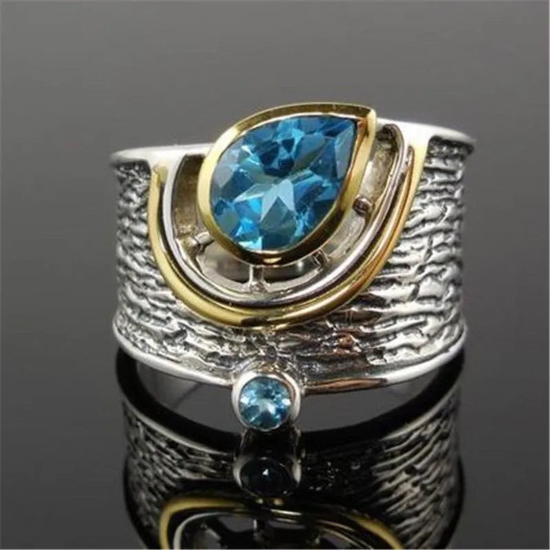 Blue zircon rhinestone ring in Chinese style with drop shape design on woman's hand