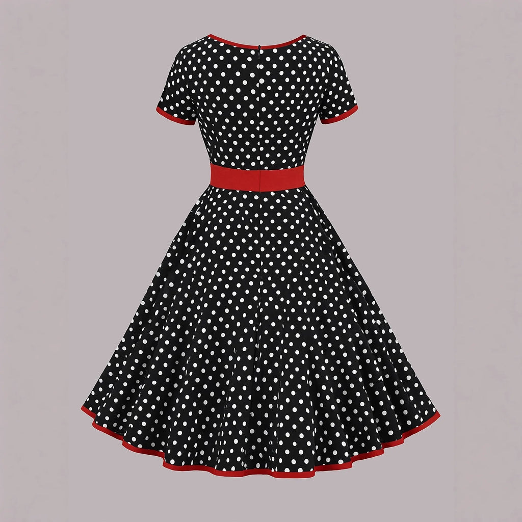 Women's multicolour polka dot dress with square collar, short sleeves, front zipper, and pleated A-line skirt.