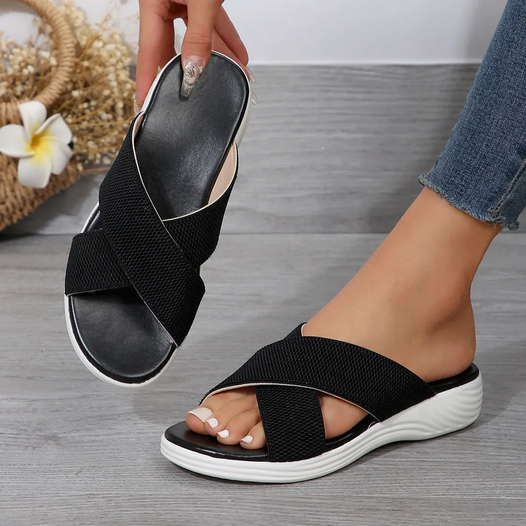 Black wedge slippers with peep-toe opening and thick rubber sole