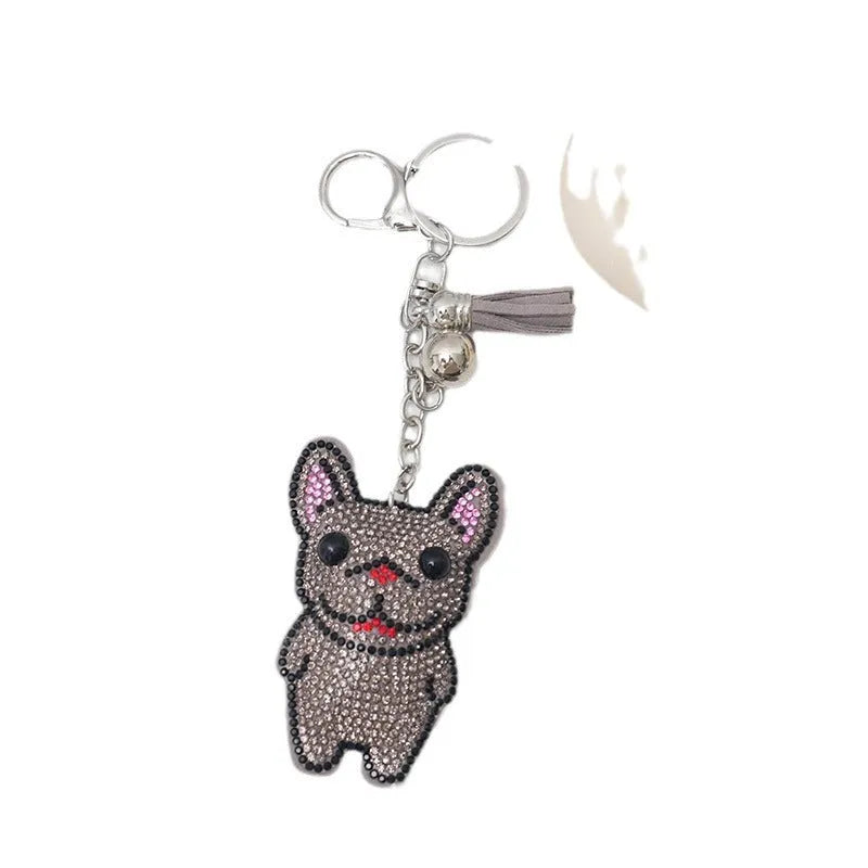 Close-up of a cartoon dog rhinestone keychain pendant on an alloy keyring