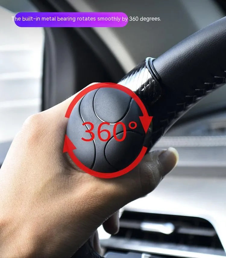 Black and blue silicone steering wheel assist balls showing size against a car steering wheel.