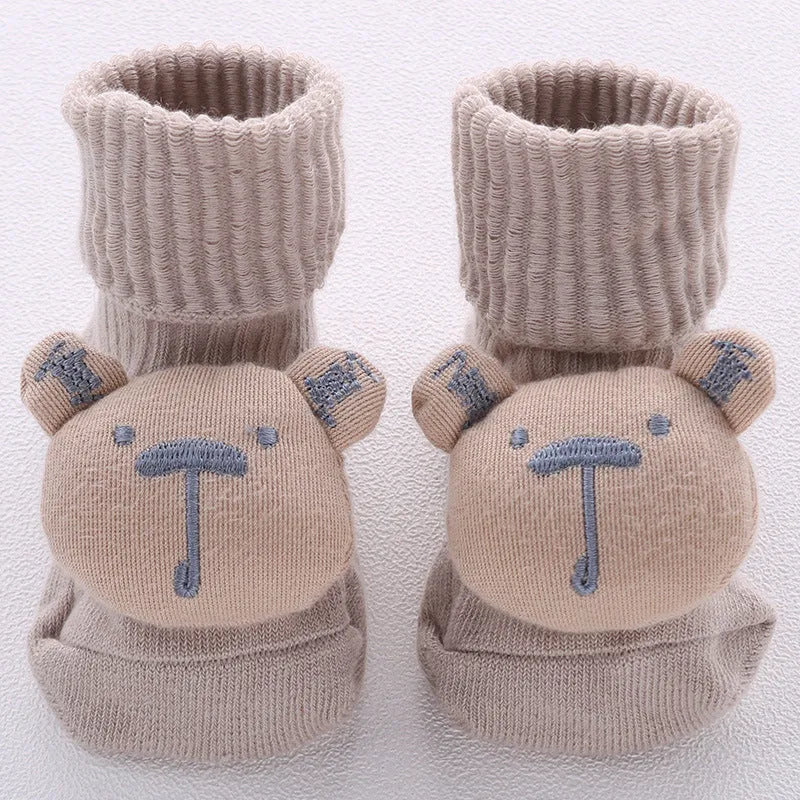 Cotton baby floor socks in various designs including blue bow and lion, showing sizes for infants 0-3 months