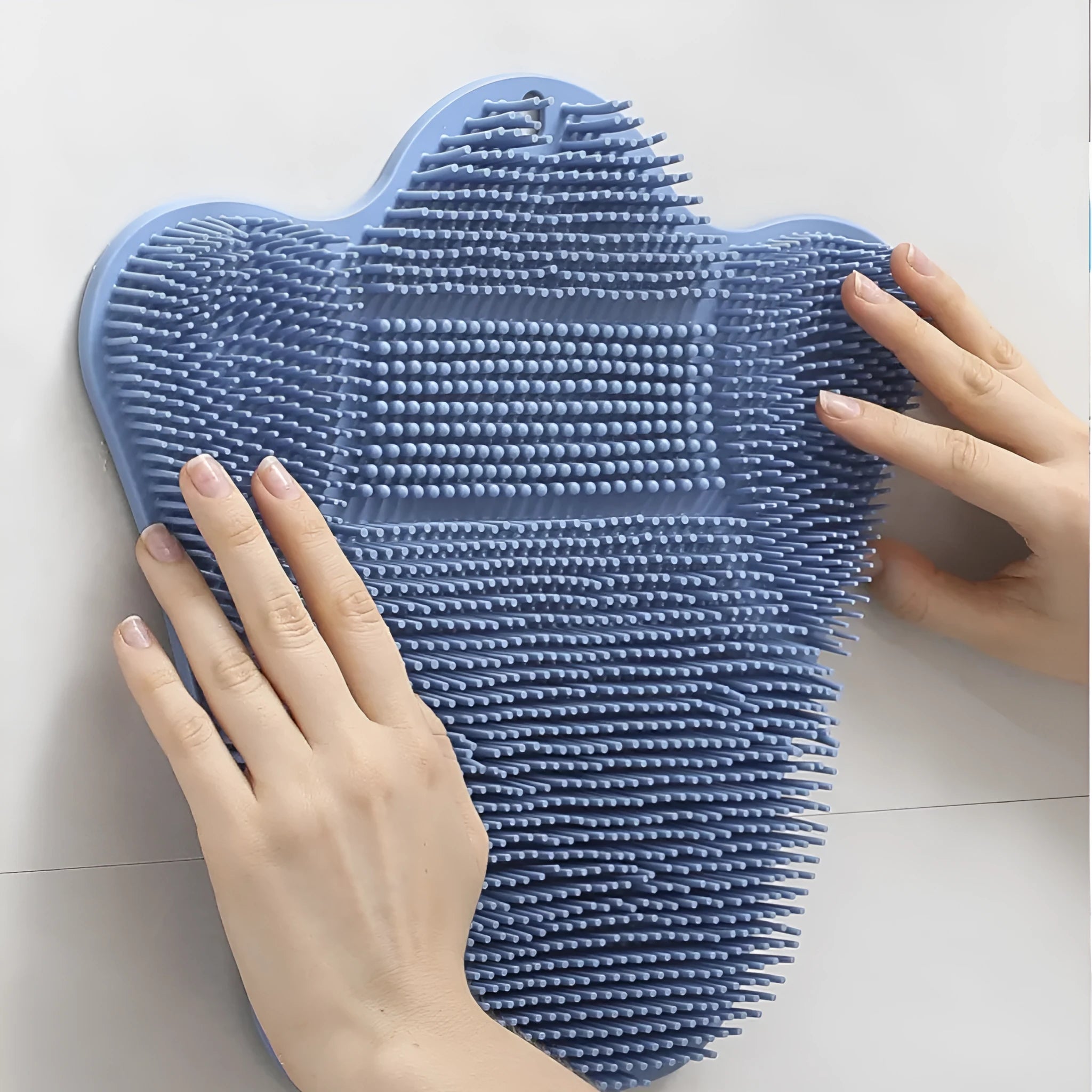 Blue silicone bath massage cushion with textured surface measuring 31 by 32 centimetres