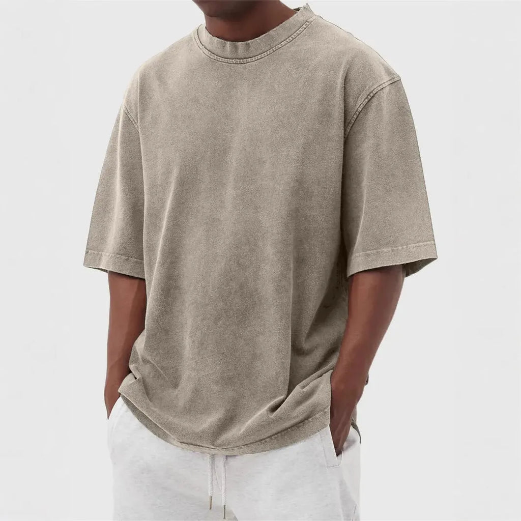Men's stone-washed distressed loose fit t-shirt in army green colour on a hanger.