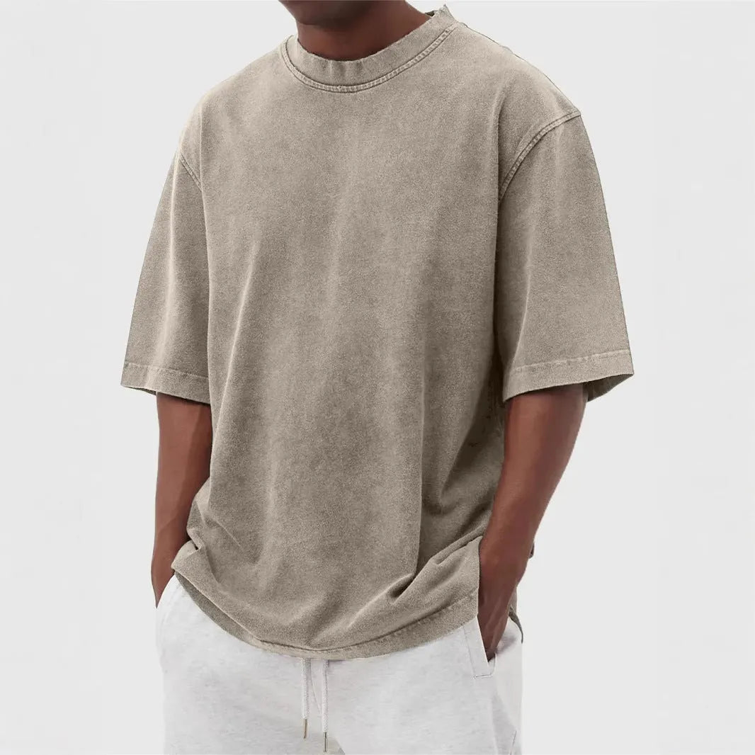 Men's stone-washed distressed loose fit t-shirt in army green colour on a hanger.