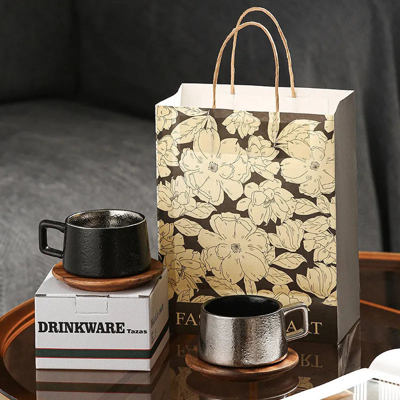 Gold and silver plated gift box next to a 250ml solid colour coffee travel mug.