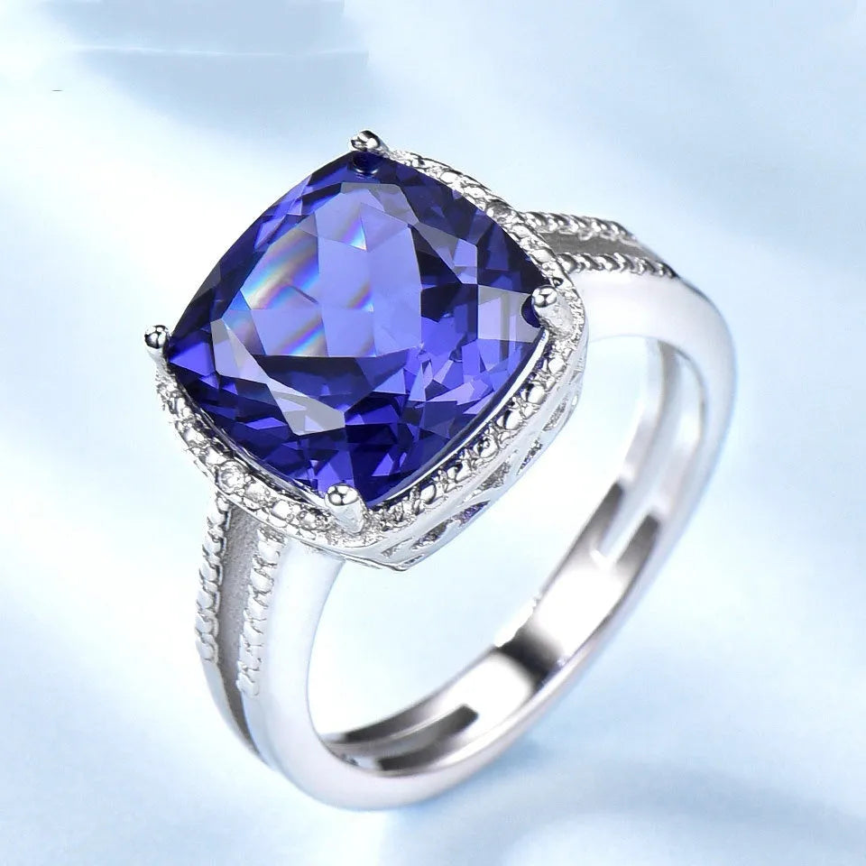 Close-up of a blue Tanzanite stone set in a polished 925 Sterling Silver women's ring.