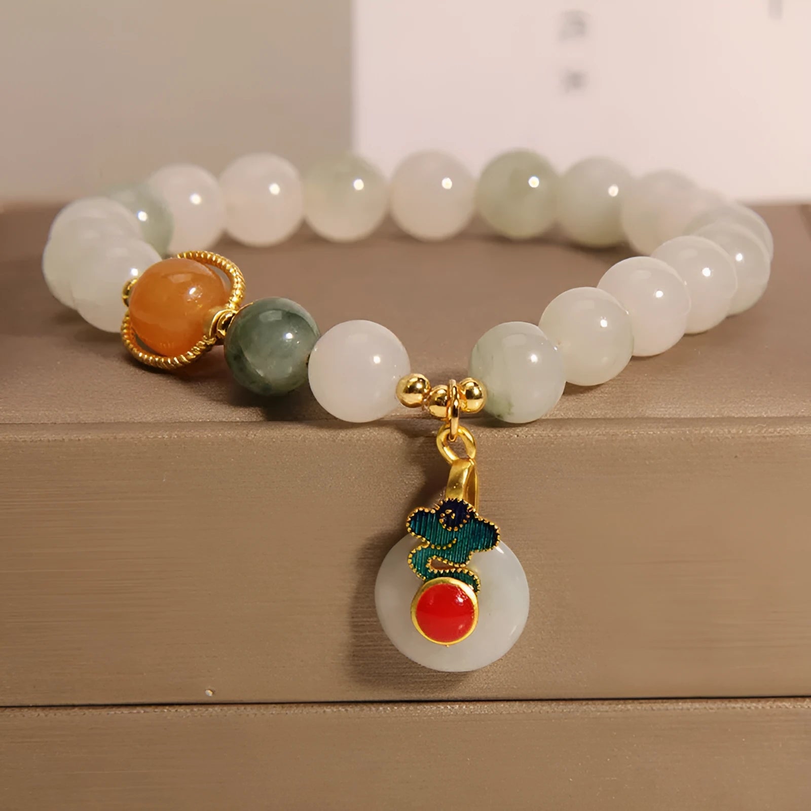 Women's ice jade crystal bracelet with xiangyun peace buckle and pearl accents on a retro-style chain.