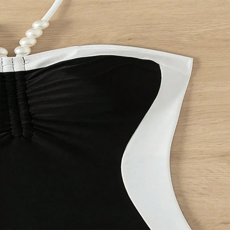 Black and white women's sleeveless one-piece swimsuit with slim fit and spaghetti straps