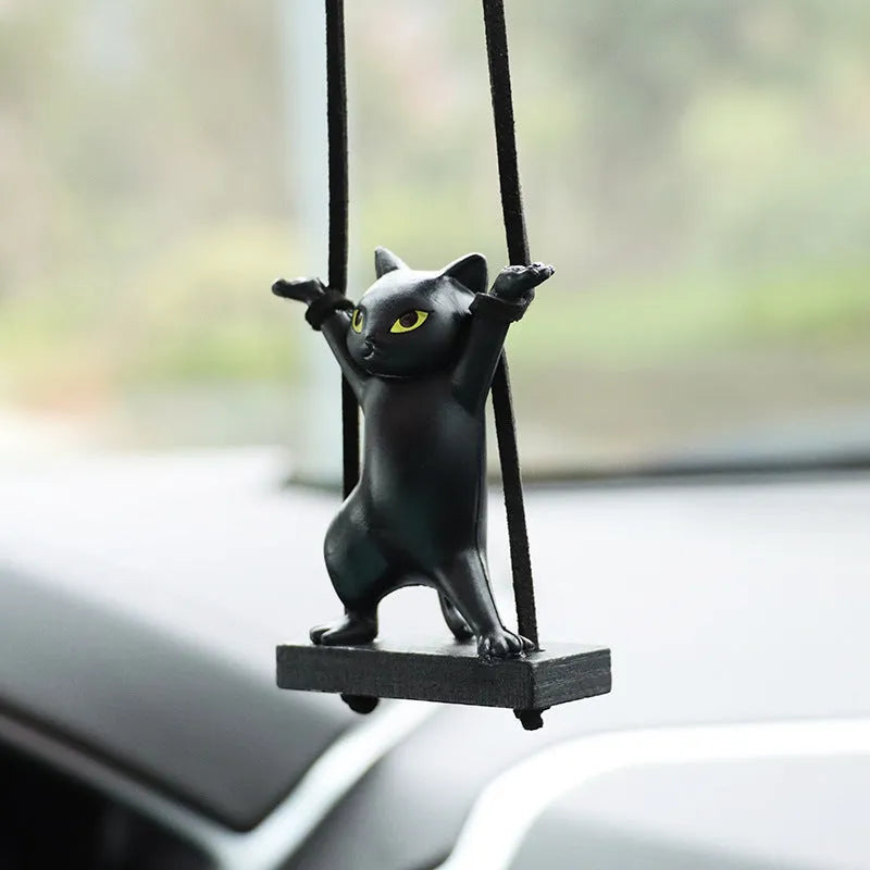 Cartoon-style resin cat pendant on a rope hanger for car interior decoration.