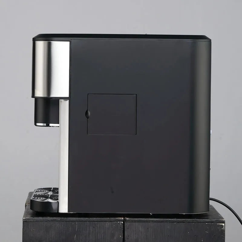 Black desktop ice maker with stainless steel ice box on a kitchen countertop.