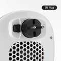 White ceramic heating electric hot air blower heater with remote control on a desk