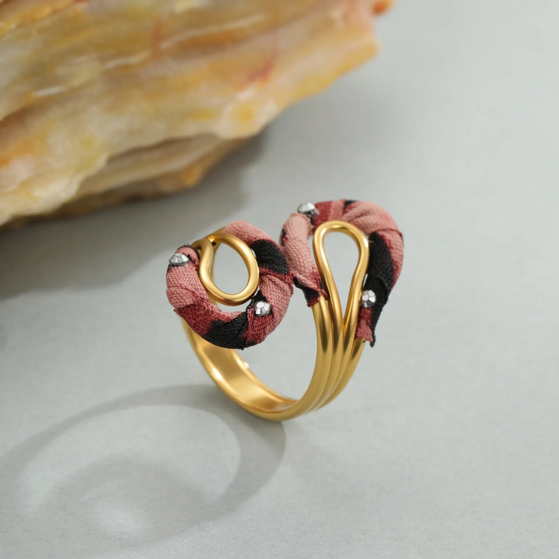 Stainless steel open mouth ring with leopard print and geometric heart or star shape design.
