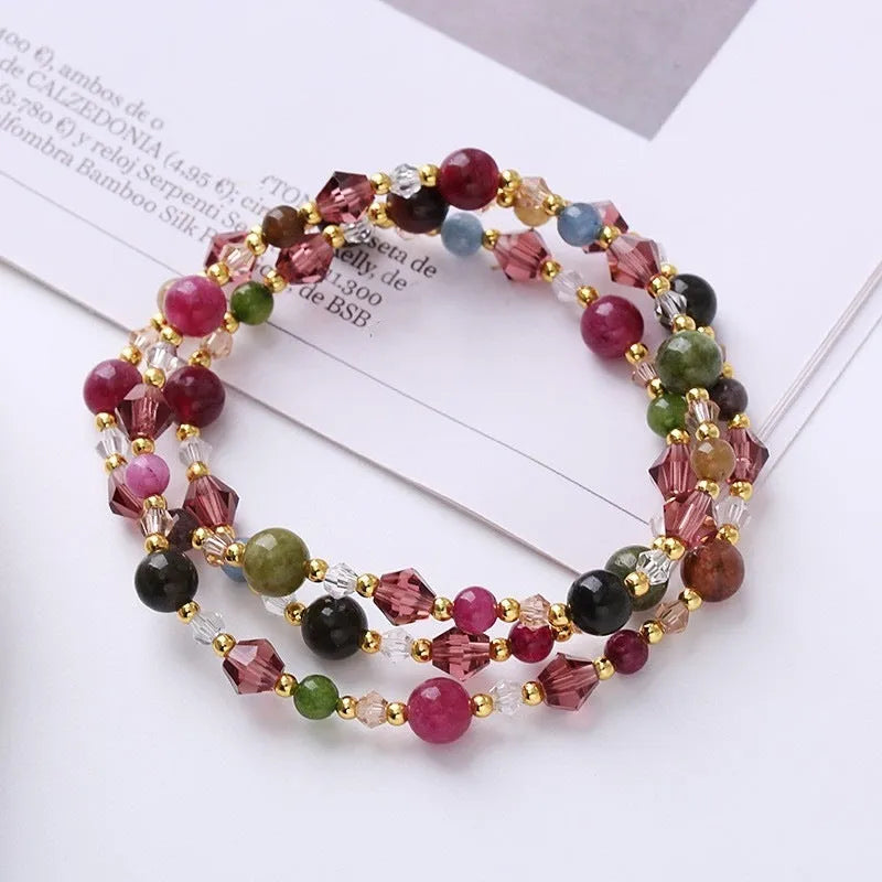 Women's adjustable crystal bracelet with tourmaline, strawberry quartz and amethyst beads on three-ring design