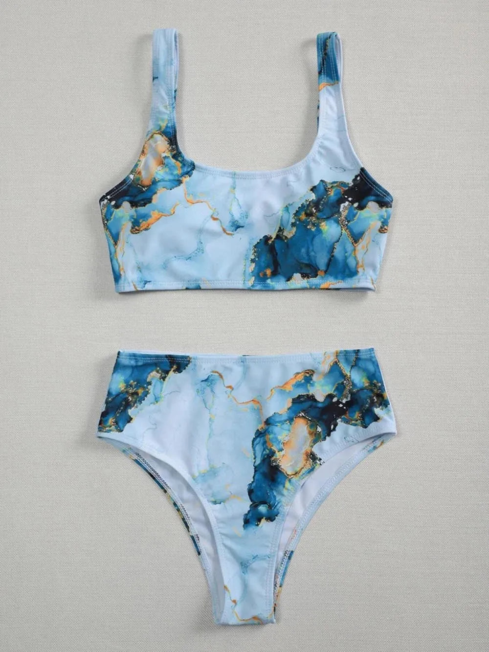 Women's high-waisted bikini set with marble tie-dye print and U-neck top