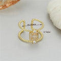 Copper-plated gold open ring with adjustable opening and asymmetric U-shaped design.