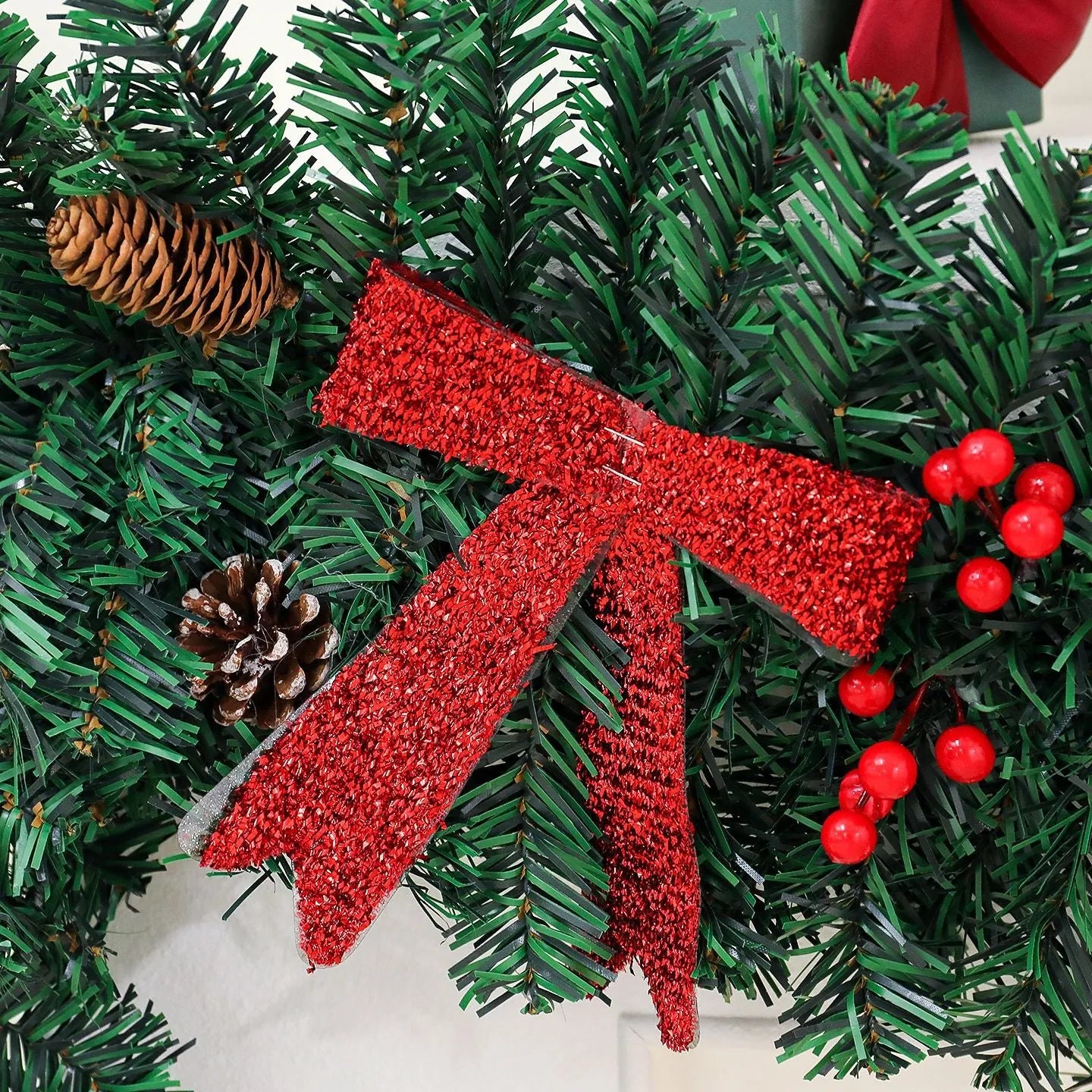 Christmas rattan decorative cane with pine cone bow attachment in showcase display arrangement