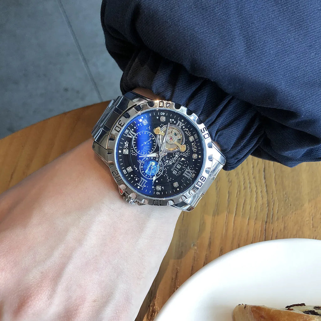 Men's silver automatic mechanical watch with starry dial, black genuine leather strap, and transparent case back showing movement