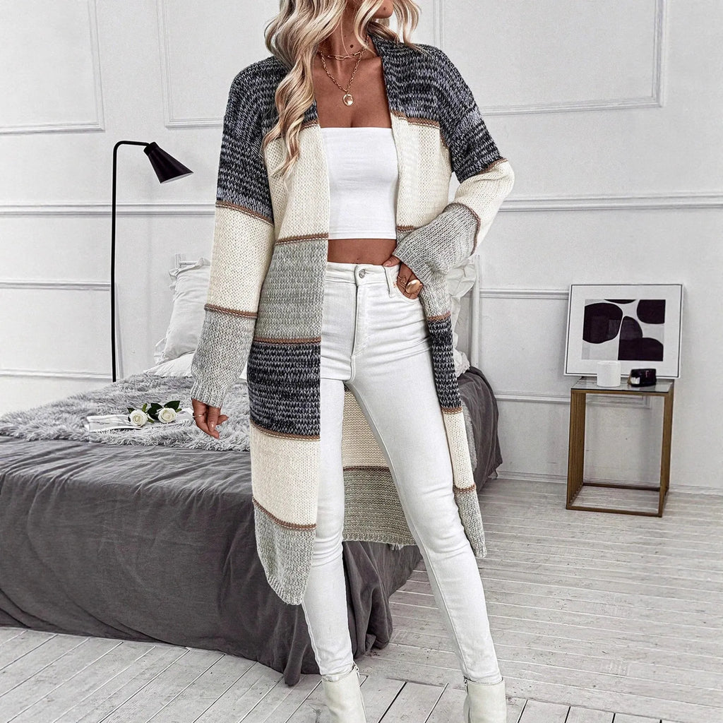 Women's grey knitted long cardigan with loose fit and stripe plaid pattern on hanger