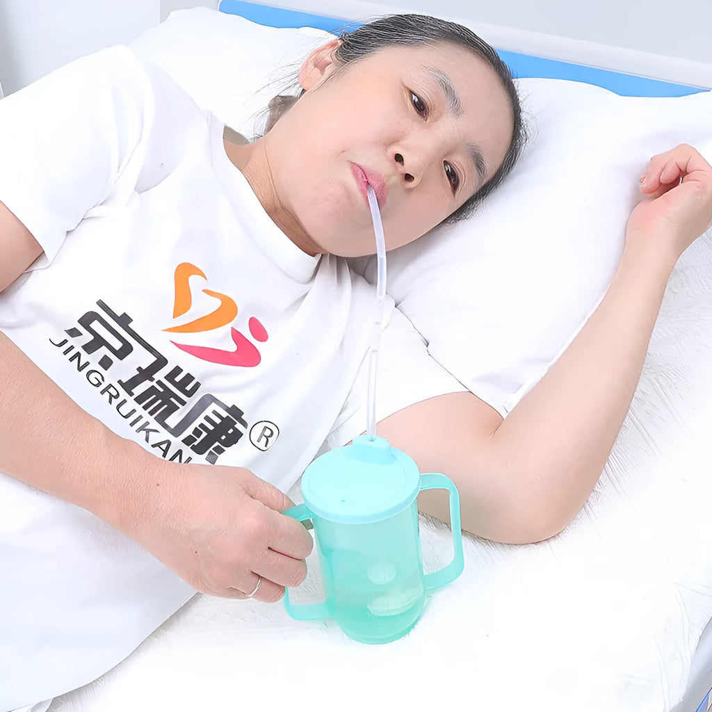 White PP plastic bedside drinking cup with slanted choke-proof spout, handle, and a blue lid