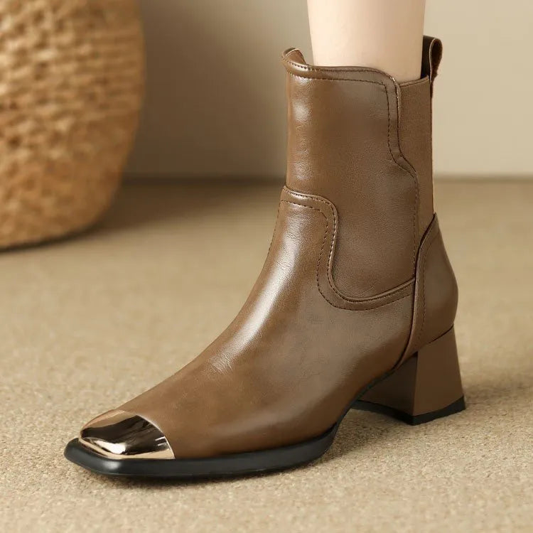 Women's brown and black slimming Martin ankle boots with side zipper and decorative metal details.