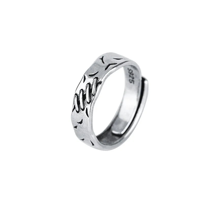 Black geometric copper ring with adjustable opening featuring round and oval design elements