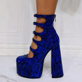 Women's black patent leather platform high heels with a thick serpentine belt and buckle closure.