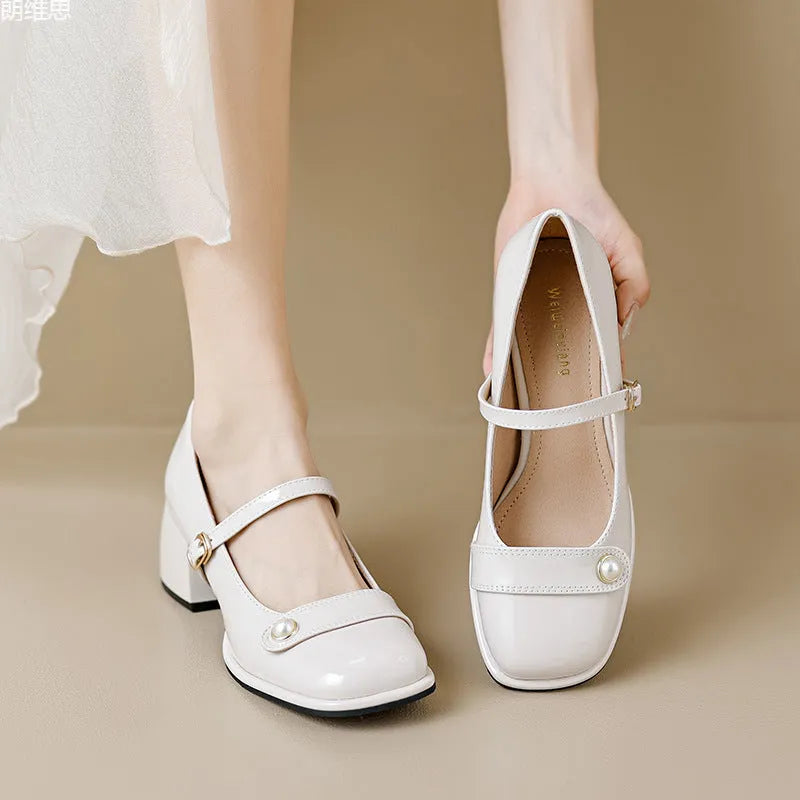 Women's patent leather chunky heel pumps with square toe and buckle fastening, shown in apricot colour.