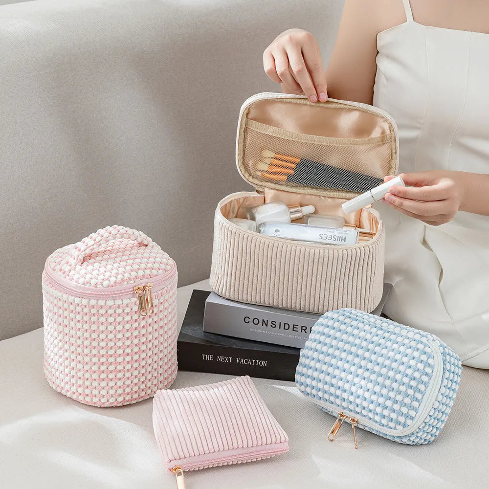 Four cube-style flannelette makeup bags in matching colour set on white background