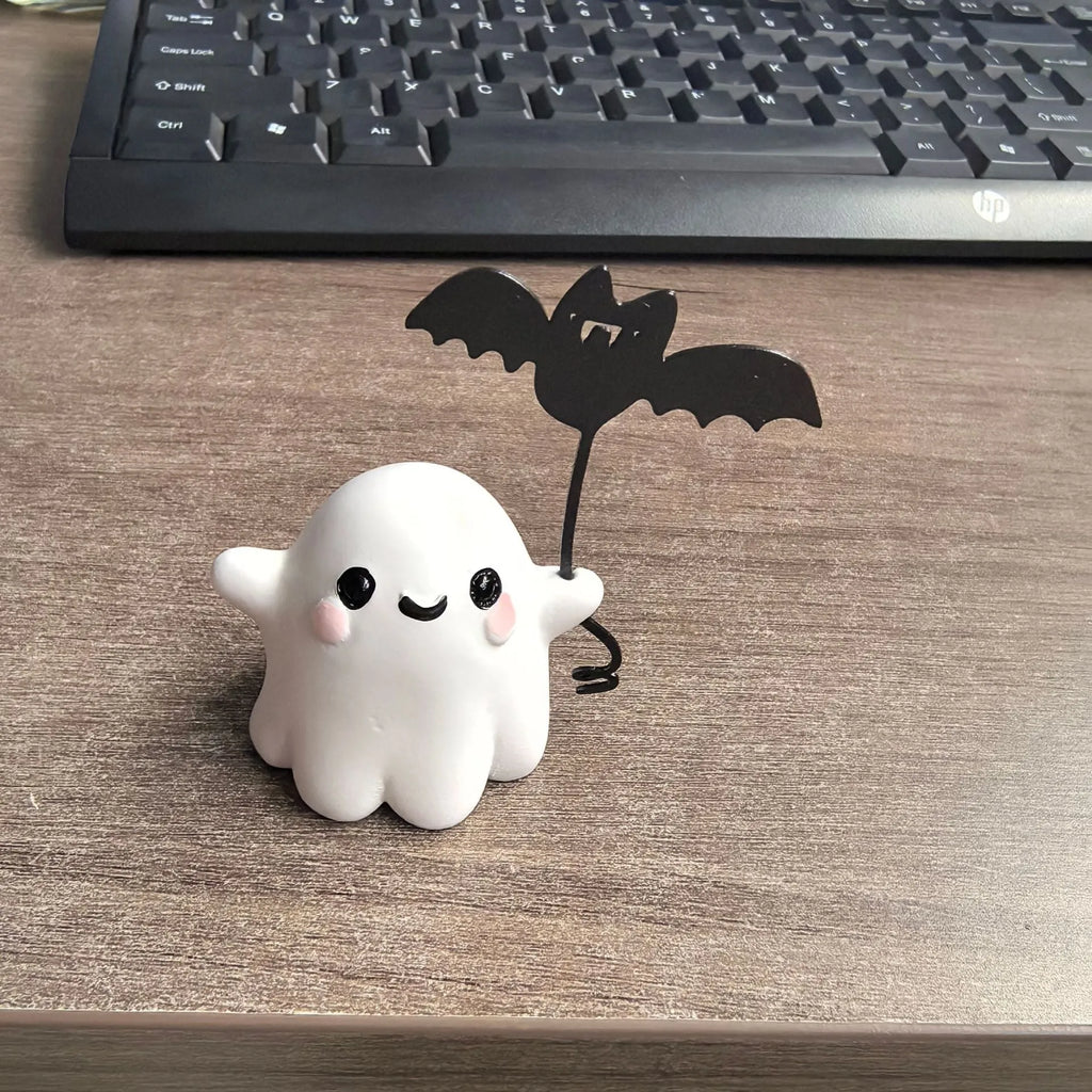 Mini resin figurine of a ghost walking a small dog, a 4x5x4cm Halloween decoration.