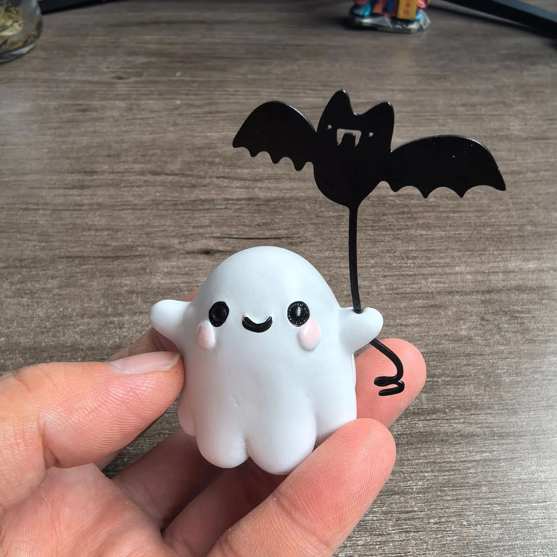 Mini resin figurine of a ghost walking a small dog, a 4x5x4cm Halloween decoration.