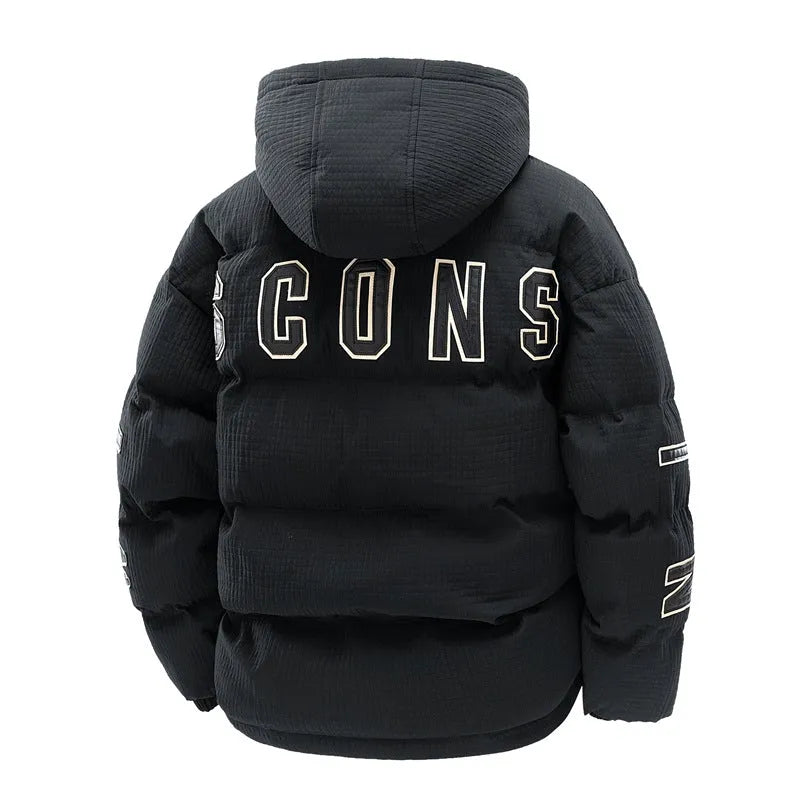 Man wearing a black hooded padded coat with a chest letter print and side pockets.
