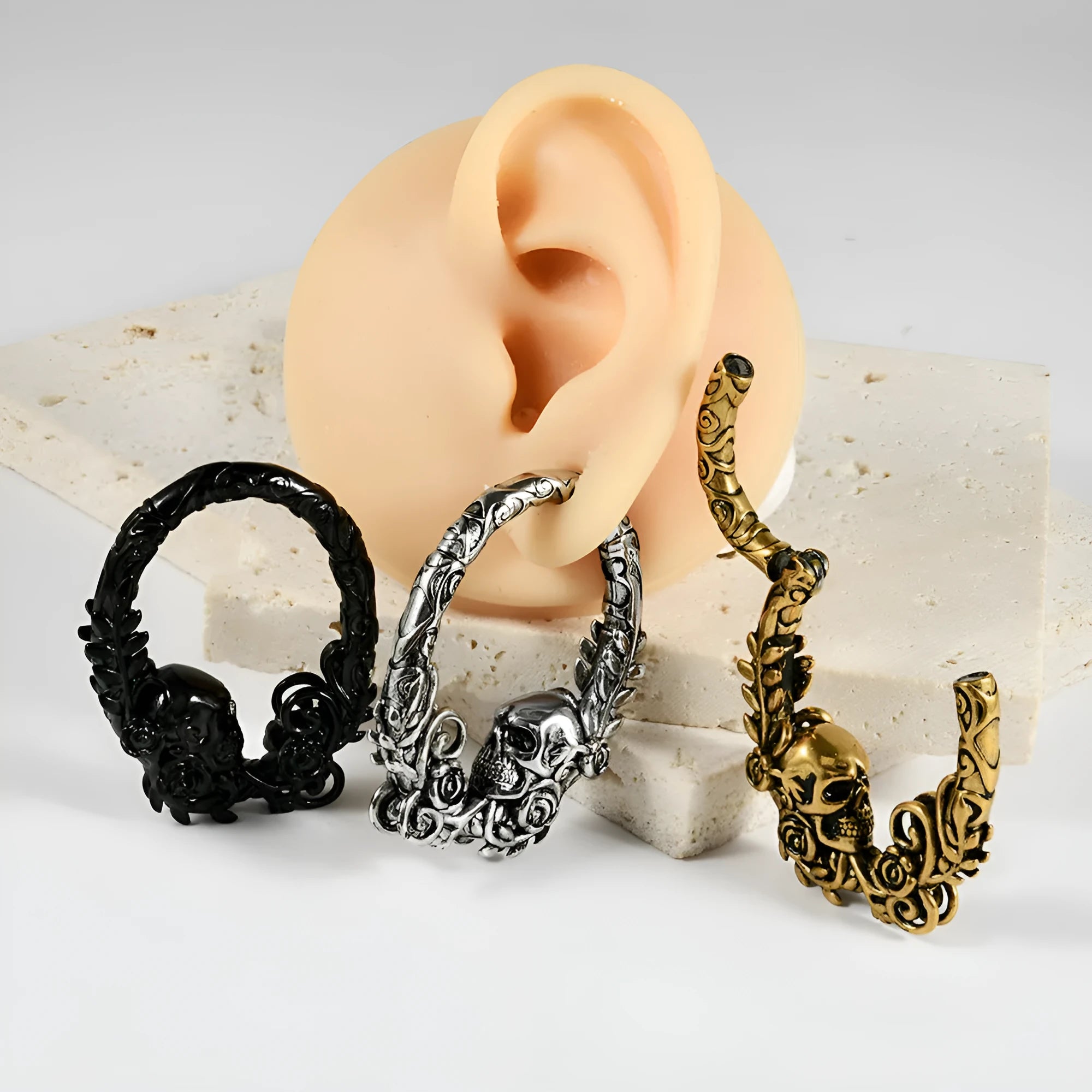 A pair of stainless steel fashion earrings featuring a detailed totem pattern, shown in one of fifteen available colour finishes.