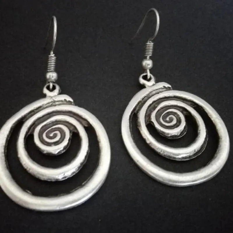 Silver geometric spiral earrings with distressed texture, measuring 2.6cm by 5cm