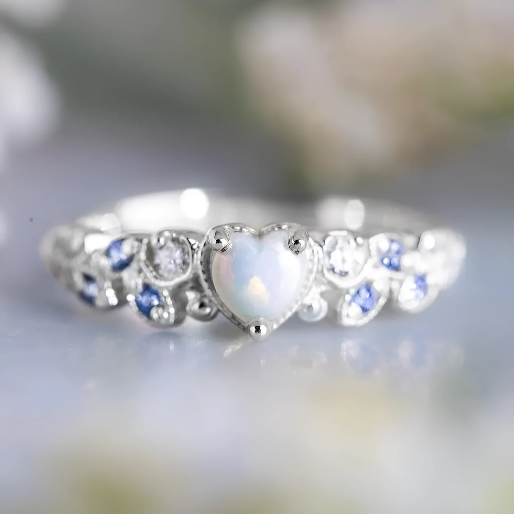 White gold tone women's heart-shaped ring with floral and oceanic pattern detailing